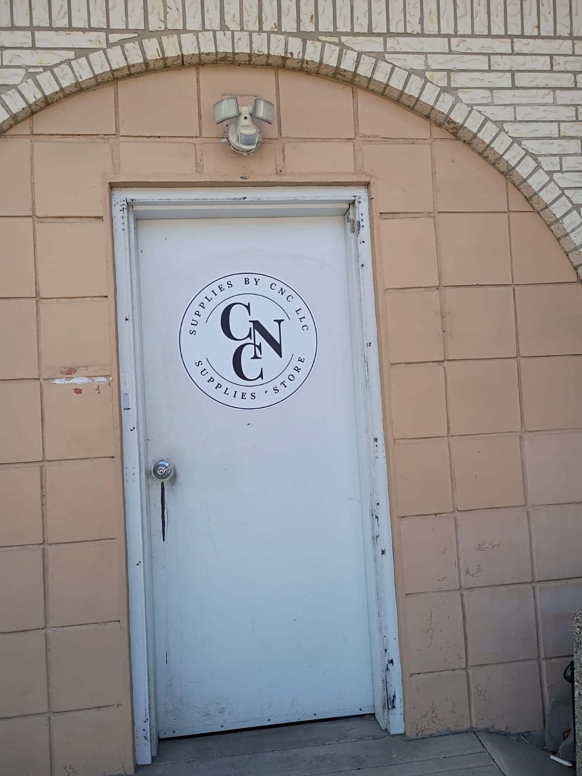 Official Supplies by CNC LLC company entrance with branded door